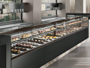 Rendering of Bakery with long Nine+ Case with black laminate showing an assortment of high end cakes and pastries